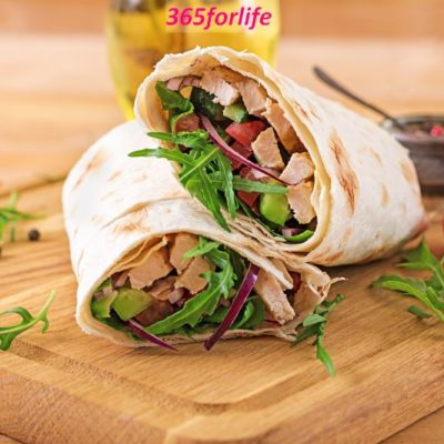 Tortillas wraps with chicken and vegetables on  wooden background. Chicken burrito. Healthy food.